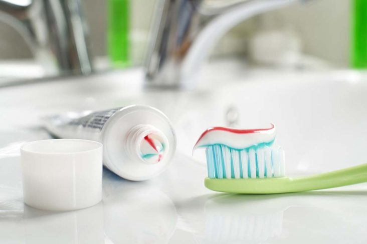Toothbrush with fluoride toothpaste on it